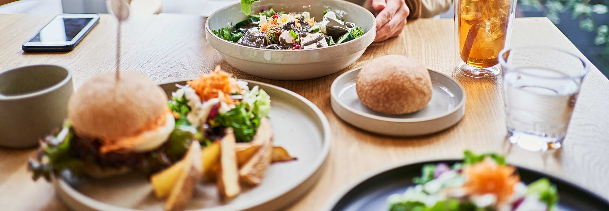 A guest enjoying various bistro-style foods on a restaurant table