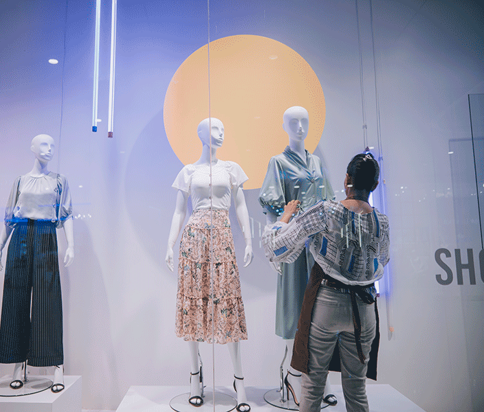 A window-dresser styling mannequins